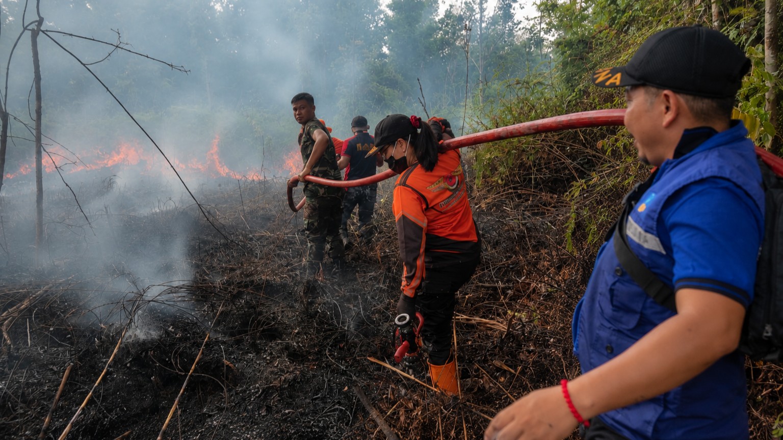 Personel Tim Reaksi Cepat (TRC) BPBD bersama petugas pemadam kebakaran dan anggota TNI melakukan upaya pemadaman kebakaran di Kabupaten Barito Selatan.